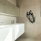 Black butterfly vinyl wall decal with ornate wings on a flat surface
