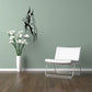 Butterfly vinyl wall decal with black winged silhouette and vine accent