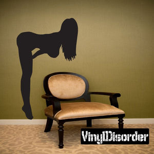 Woman bending over silhouette decal with dark figure