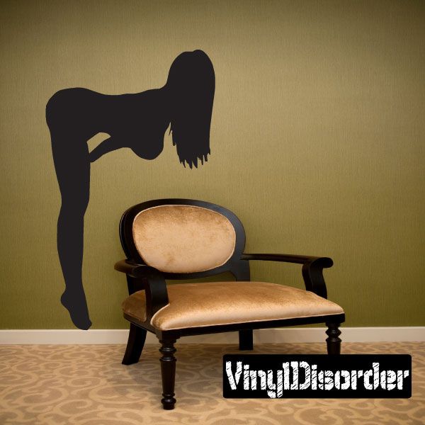 Woman bending over silhouette decal with dark figure