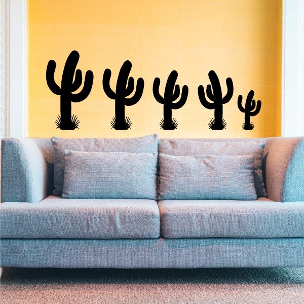 Cactus decal set with black outlined cactus silhouettes on wall above couch
