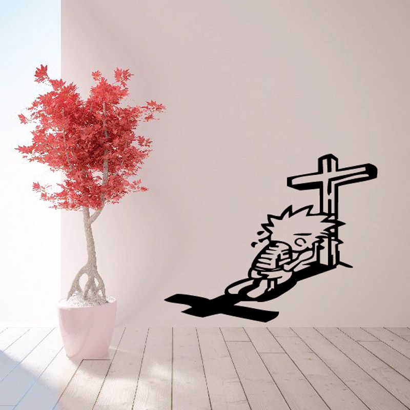 Black crying praying decal featuring a kneeling figure and a cross
