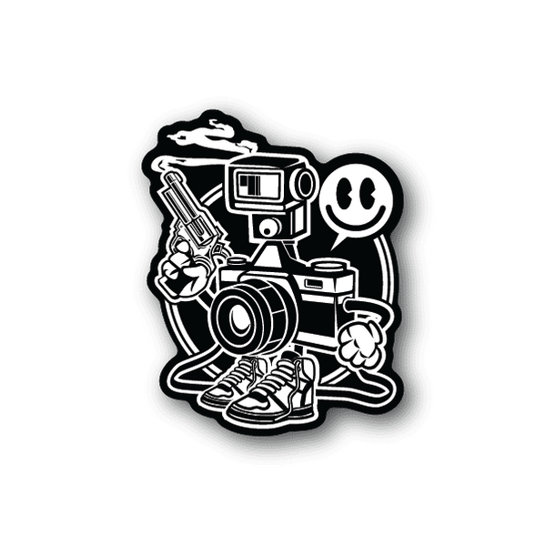 Vinyl sticker with cartoon camera character holding a pistol and wearing sneakers