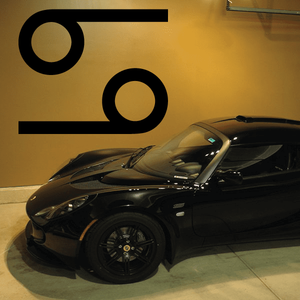 Black simple symbol decal with circular and bar shapes on a vehicle
