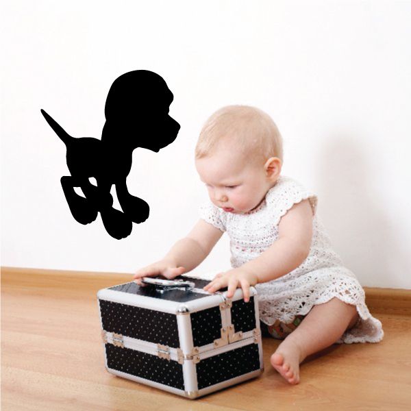 Cartoon dog decal in black silhouette with raised tail and butterfly-like accessory