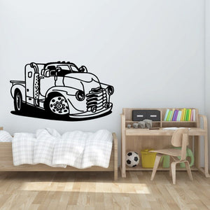 Cartoon truck wall decal in black line art, front view with bold wheels and lights.