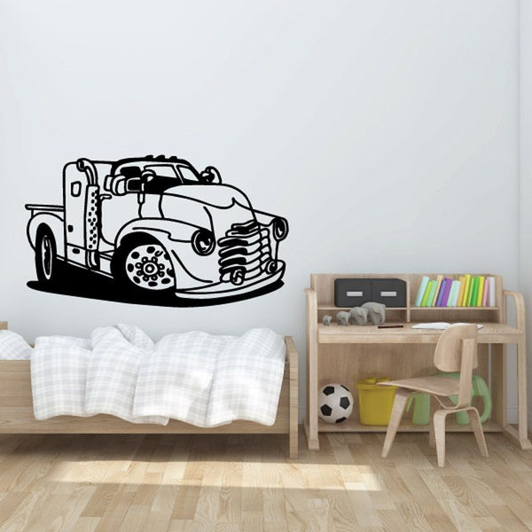 Cartoon truck wall decal in black line art, front view with bold wheels and lights.