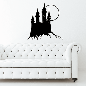 Castle and Moon wall decal: black castle silhouette with moon over white tufted sofa