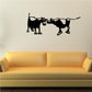 Cow couple wall decal with two black cattle silhouettes facing each other