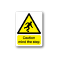 Caution mind the step sticker with yellow warning triangle and walking figure text