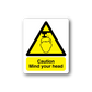 Caution sticker with yellow warning triangle and “Mind your head” text