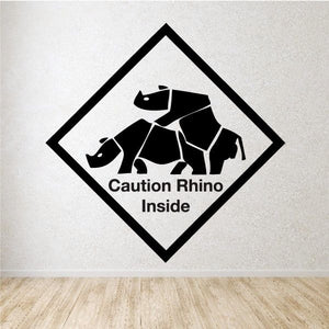 Diamond caution decal: black rhino silhouettes with 'Caution Rhino Inside' text