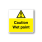Rectangular caution wet paint sticker with yellow background, black text, and warning triangle