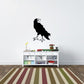 Black raven wall decal perched on a small branch with feet extended