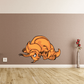 Charging triceratops sticker, orange cartoon dinosaur with raised horns