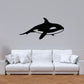 Black orca whale wall decal with stylized splash tail