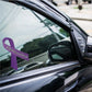 Purple awareness ribbon vinyl sticker on car window glass