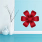 Red ribbon flower sticker with layered bow petals, festive Christmas design