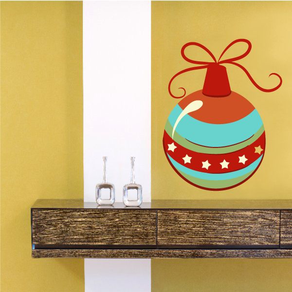 Round Christmas ornament vinyl decal with red bow and bell, teal and red striped body