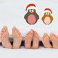 Penguin sticker set: two cartoon penguins with red Santa hats and pink bellies