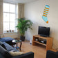 Blue striped Christmas stocking sticker on a wall, with gold-toe detail