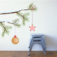 Vinyl wall decal of Christmas tree branch with gold ornament and red star