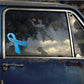 Blue awareness ribbon vinyl sticker on a car window