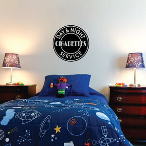 Circular “DAY & NIGHT CIGARETTES SERVICE” decal in black and white