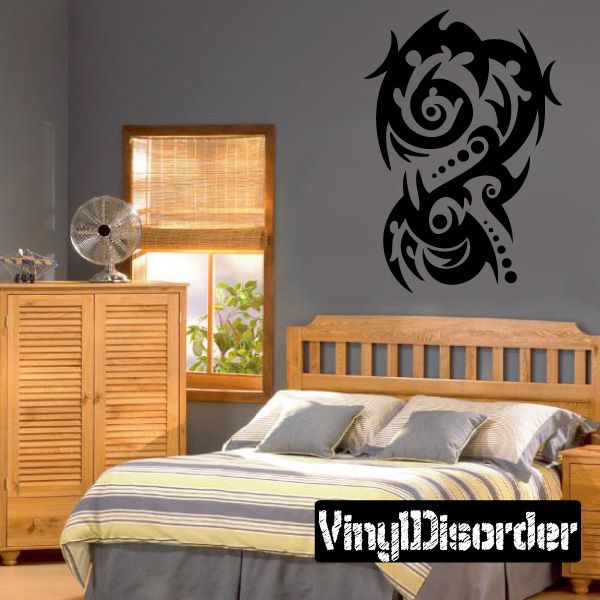 Tribal vinyl wall decal with black curled motifs and two face-like figures