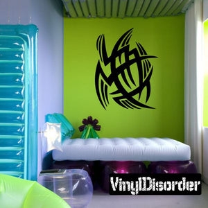Tribal vinyl wall decal with black abstract bird design on a green wall