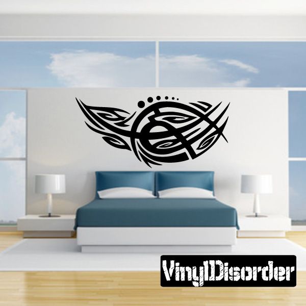 Tribal vinyl wall decal with black circular knot design and wing-like accents
