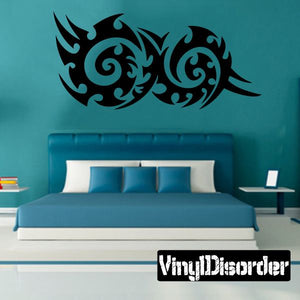 Tribal wall decal with two mirrored swirling motifs, dark vinyl sticker
