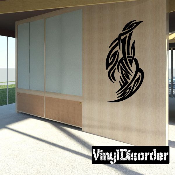 Tribal vinyl wall decal with black winged emblem on wall surface