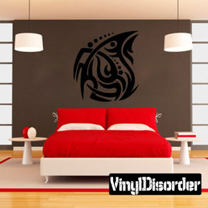 Tribal vinyl wall decal with black swirl figure on a light wall