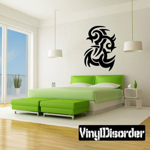 Black tribal vinyl wall decal with swirling dragon-like design