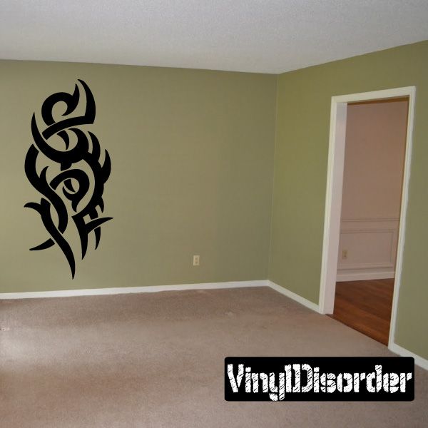 Tribal vinyl wall decal with black decorative flame-like design on green wall