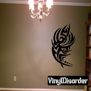Tribal vinyl wall decal with black stylized spiral emblem and dot accents