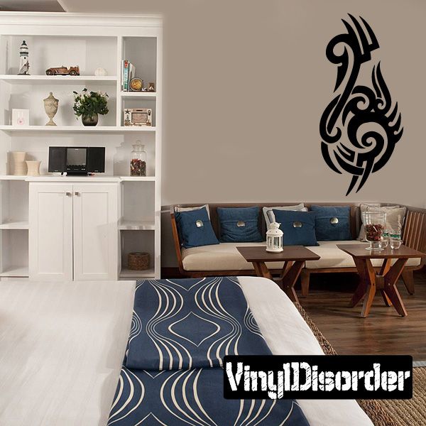 Tribal vinyl wall decal with black flame-like ornament on a light wall