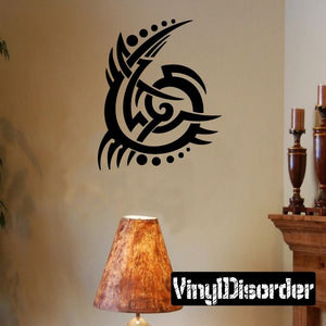 Black tribal vinyl wall decal with circular dot accents and curved dragon-like emblem