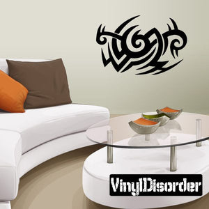 Black tribal vinyl wall decal with swirling curved shapes and two horns