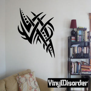 Black tribal vinyl wall decal with stylized cross-like knot and flame shapes