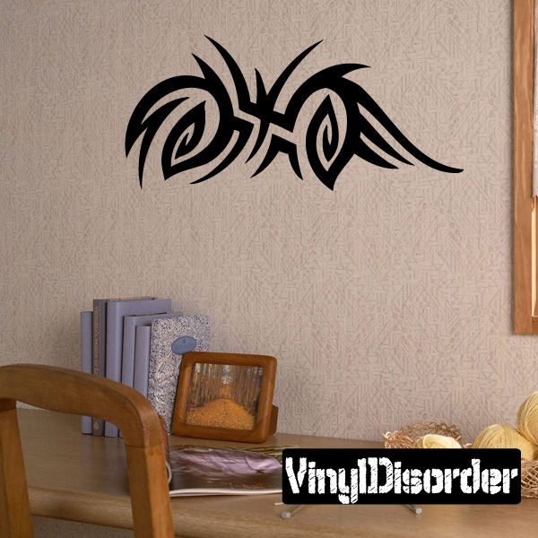 Tribal vinyl wall decal with bold black scroll and eye motif