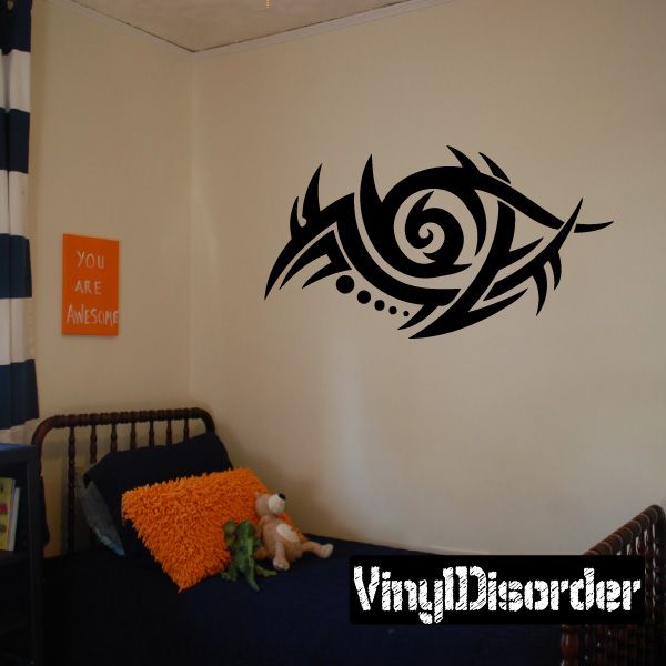 Black tribal wall decal with swirling eye and dot accents