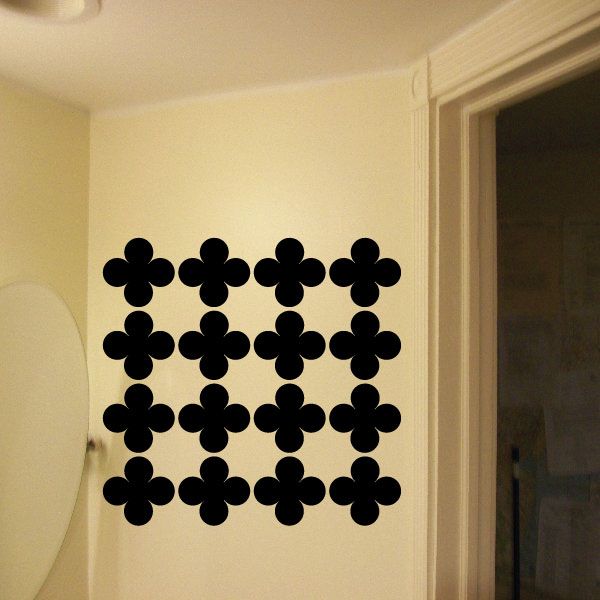 Clover wall decal with repeating black four-leaf flower pattern on wall