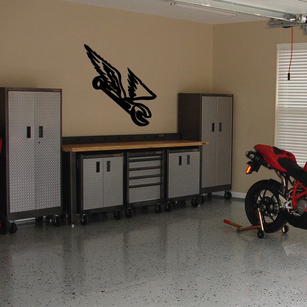 Black winged wrench wall decal with stylized wings and wrench icon