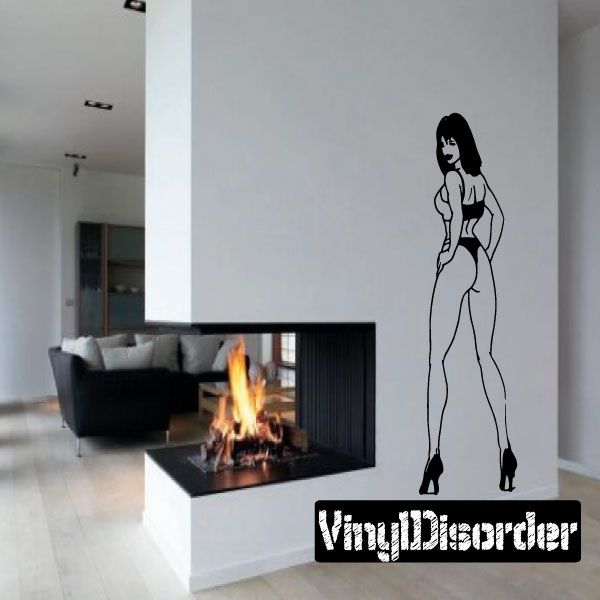 Wall decal of black-outlined woman in high heels looking back, with stylized text