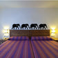 Black connected elephants wall decal with four linked elephant silhouettes