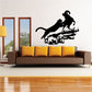Black wall decal of a leaping cougar attacking a ram silhouette on grass