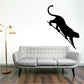 Cougar stepping down wall decal with black silhouette of leaping animal