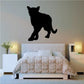 Black cougar walking forward wall decal silhouette above bed